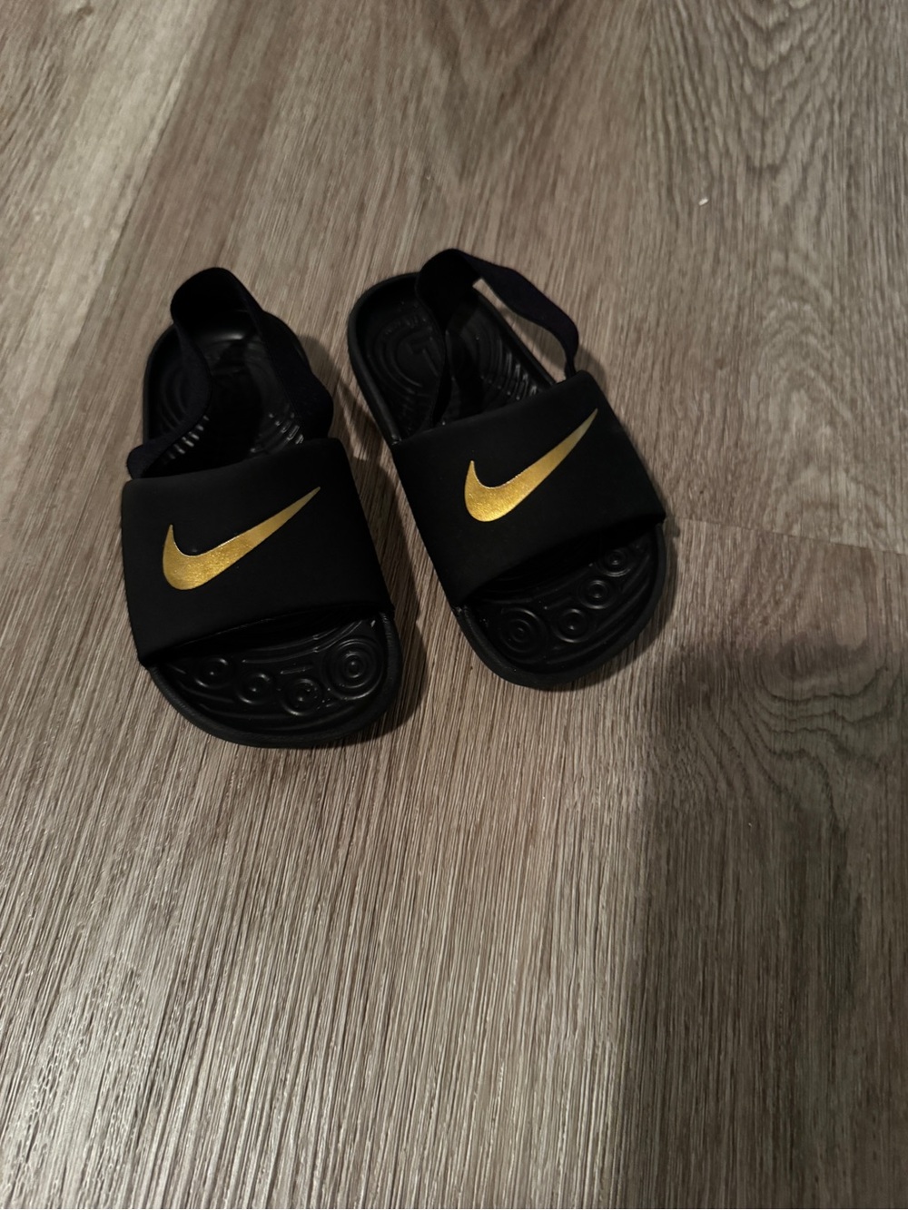 Nike Kids Black Slide Sandals with Gold Swoosh